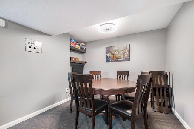 dining space with carpet floors and baseboards