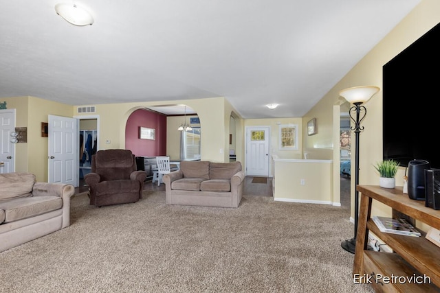 581 Cumings Ct NW, Sparta, MI 49345 - carpeted living area featuring an inviting chandelier, arched walkways, and visible vents
