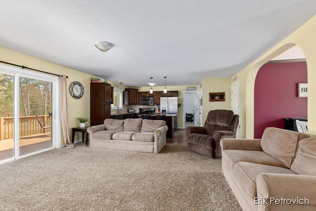 581 Cumings Ct NW, Sparta, MI 49345 - carpeted living area featuring arched walkways
