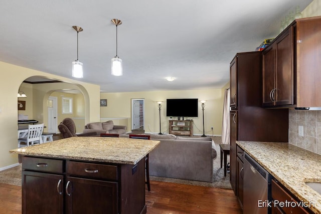 581 Cumings Ct NW, Sparta, MI 49345 - kitchen featuring arched walkways, open floor plan, dark wood-type flooring, and dishwasher