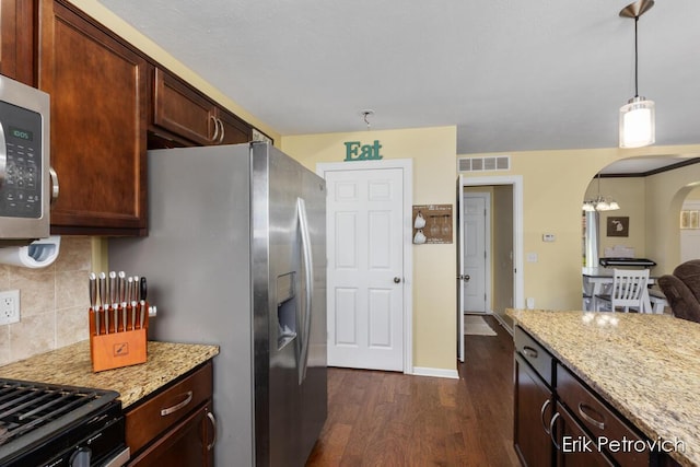 581 Cumings Ct NW, Sparta, MI 49345 - kitchen featuring visible vents, decorative backsplash, light stone counters, arched walkways, and dark wood finished floors