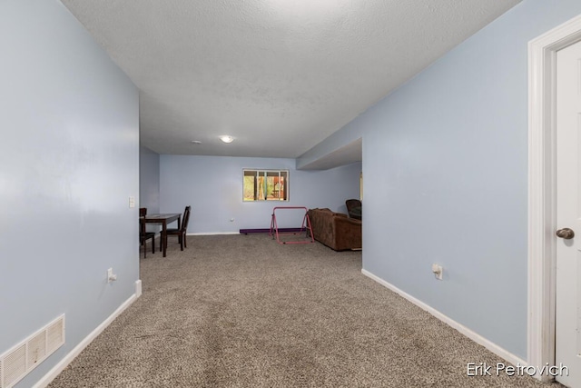 581 Cumings Ct NW, Sparta, MI 49345 - living area with carpet flooring, a textured ceiling, visible vents, and baseboards