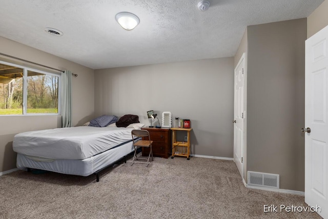 581 Cumings Ct NW, Sparta, MI 49345 - carpeted bedroom with a textured ceiling, baseboards, and visible vents