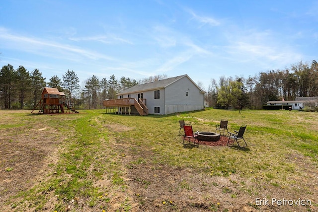 581 Cumings Ct NW, Sparta, MI 49345 - view of yard featuring a playground, stairs, a fire pit, and a deck