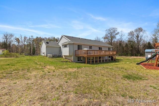 581 Cumings Ct NW, Sparta, MI 49345 - rear view of property with a yard, a deck, and a playground
