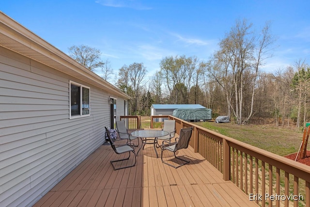 581 Cumings Ct NW, Sparta, MI 49345 - wooden terrace with a lawn and outdoor dining space
