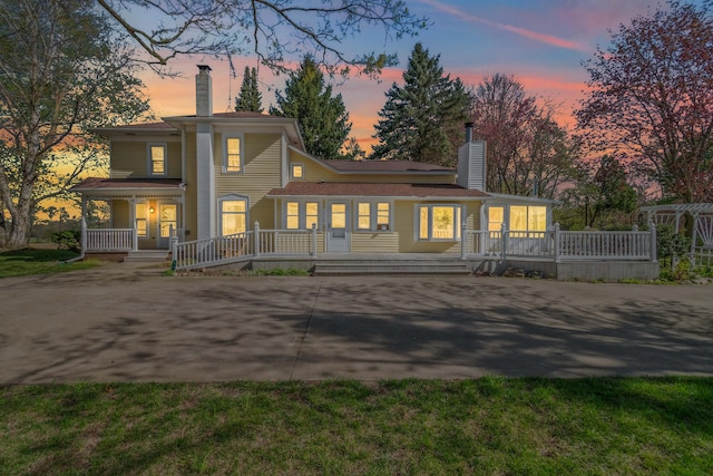473 Block Rd, Coldwater, MI 49036 - back of house featuring covered porch, a chimney, and concrete driveway