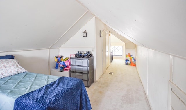 bedroom featuring light carpet and lofted ceiling