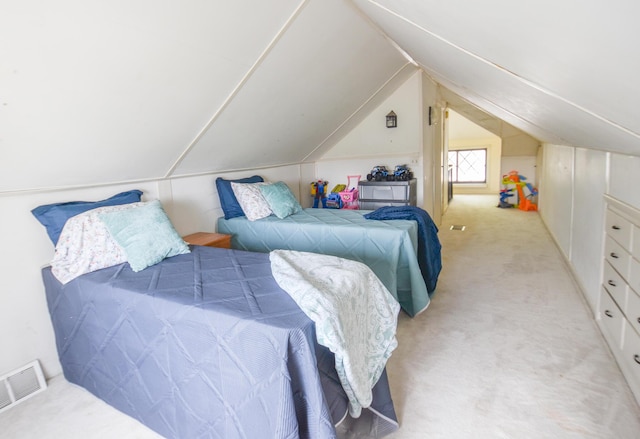 bedroom featuring visible vents, vaulted ceiling, and light carpet