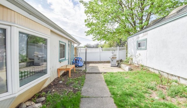 view of yard featuring a patio and fence