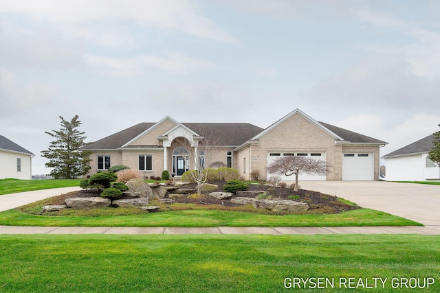 view of front of house featuring an attached garage, a front lawn, driveway, and brick siding