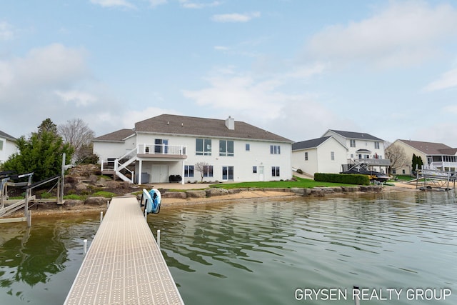 dock area with a residential view, a water view, and stairway