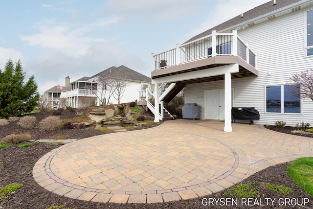 rear view of property with a patio area, a wooden deck, and stairway