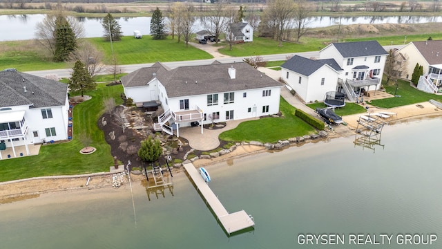 drone / aerial view with a residential view and a water view