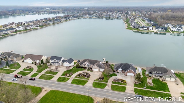 drone / aerial view featuring a water view and a residential view