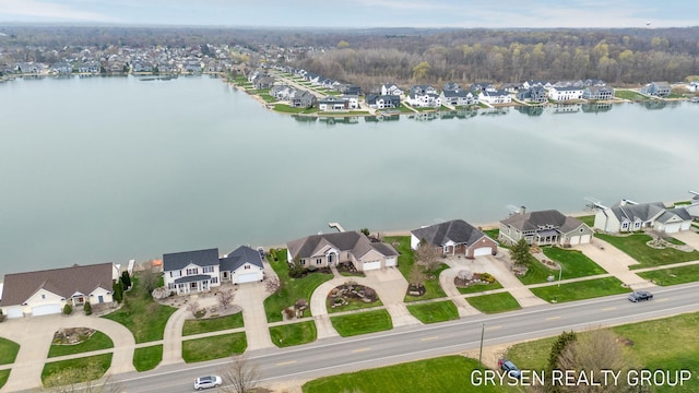 birds eye view of property with a water view and a residential view