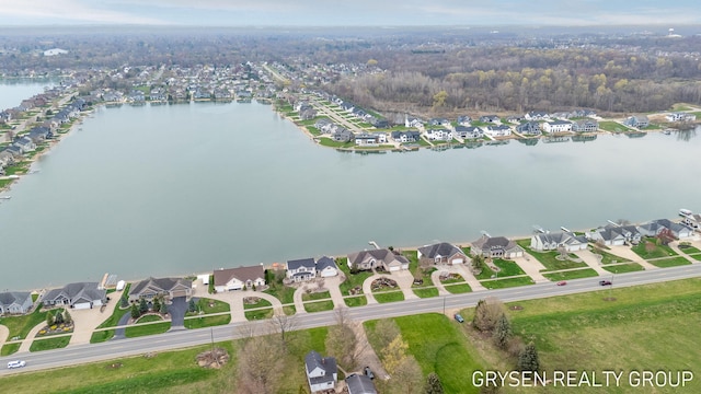 birds eye view of property with a water view and a residential view
