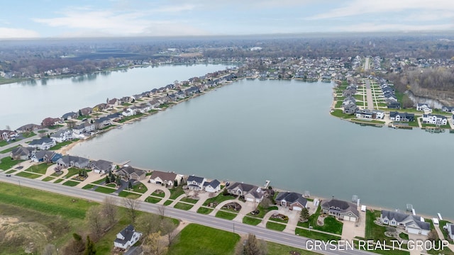 drone / aerial view with a residential view and a water view