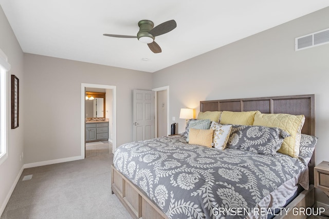 carpeted bedroom featuring visible vents, a ceiling fan, baseboards, and connected bathroom