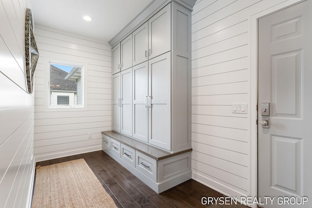 mudroom featuring wooden walls, dark wood-style flooring, baseboards, and recessed lighting