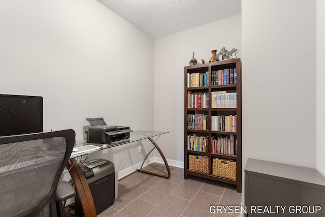 office with baseboards and a textured ceiling