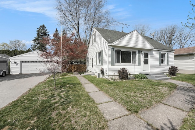 view of front of property featuring a garage, a shingled roof, a front lawn, and an outbuilding
