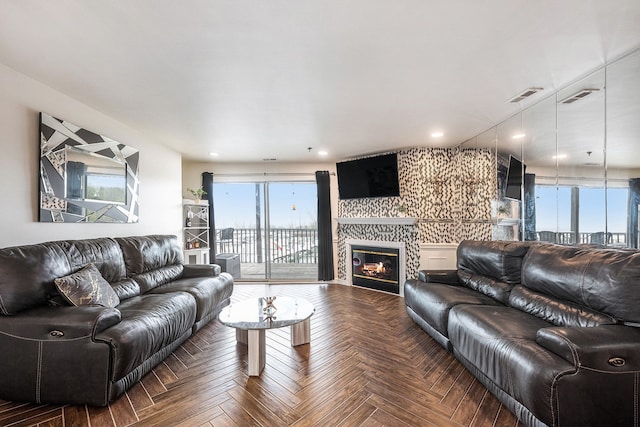 living room featuring visible vents and a fireplace