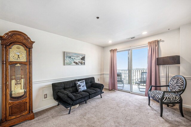 carpeted living room with recessed lighting and visible vents