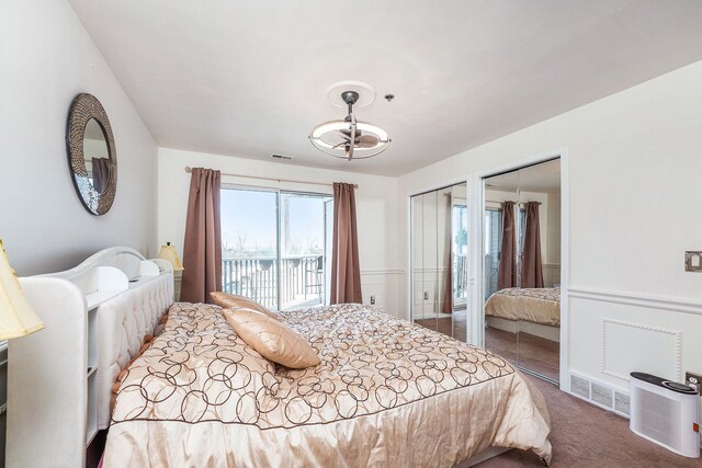 37510 Jefferson Ave Unit 203, Harrison Township, MI 48045 - carpeted bedroom featuring two closets, a chandelier, and access to exterior