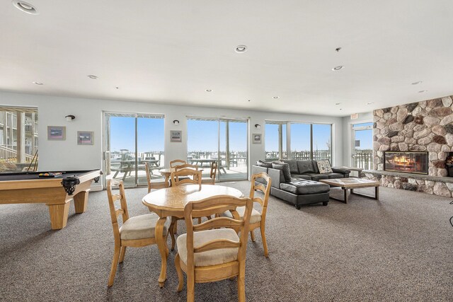 dining room featuring a fireplace, billiards, light carpet, and recessed lighting