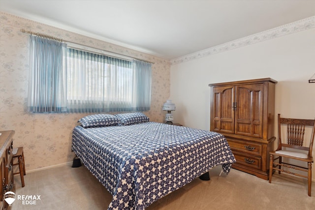bedroom featuring wallpapered walls, light colored carpet, and baseboards