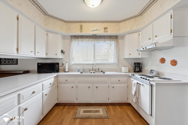 kitchen with white electric range oven, black microwave, a sink, and light wood-type flooring