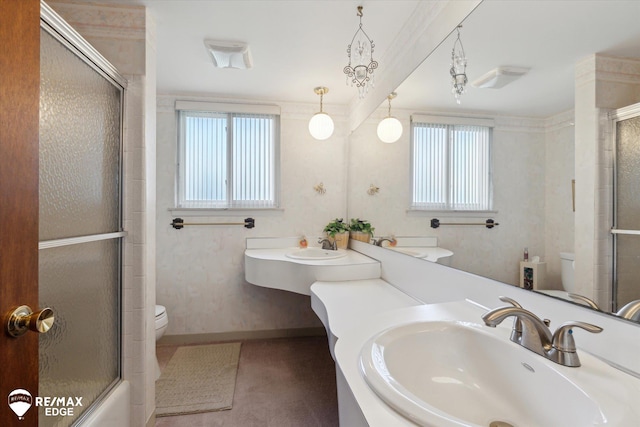 full bath featuring an enclosed shower, toilet, a healthy amount of sunlight, and a sink