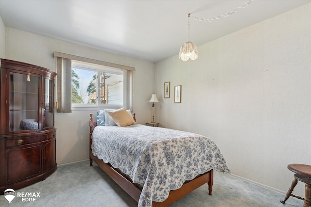 bedroom featuring baseboards and light colored carpet
