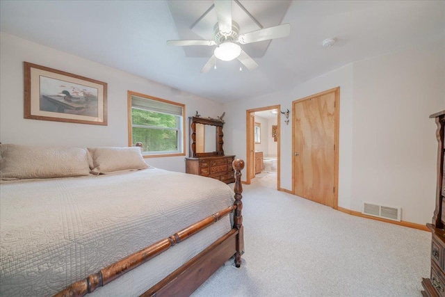 4335 Kings Corner Rd, Glennie, MI 48737 - carpeted bedroom with baseboards, ceiling fan, ensuite bath, and visible vents