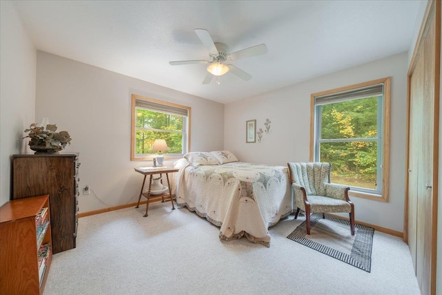 4335 Kings Corner Rd, Glennie, MI 48737 - bedroom with baseboards, light colored carpet, and ceiling fan