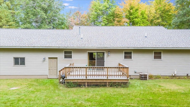 4335 Kings Corner Rd, Glennie, MI 48737 - back of house featuring a lawn, a shingled roof, and a deck