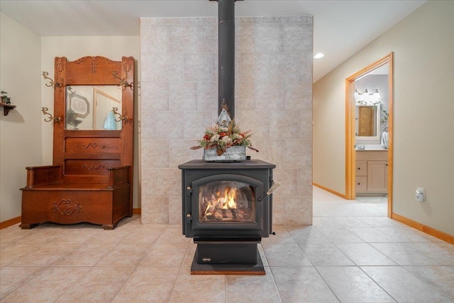 4335 Kings Corner Rd, Glennie, MI 48737 - room details with baseboards, a wood stove, and recessed lighting