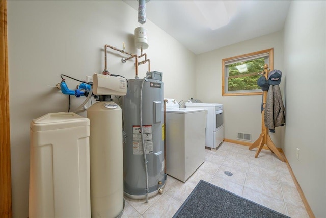 4335 Kings Corner Rd, Glennie, MI 48737 - laundry area with laundry area, independent washer and dryer, visible vents, light tile patterned floors, and water heater