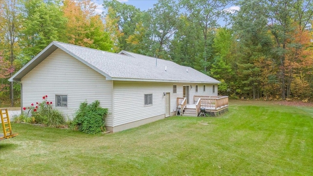 4335 Kings Corner Rd, Glennie, MI 48737 - rear view of property featuring a lawn, a wooden deck, and a shingled roof