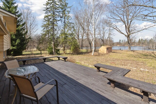 711 Sylvanwood Dr, Troy, MI 48085 - wooden terrace with a storage unit, a water view, a fenced backyard, and an outdoor structure