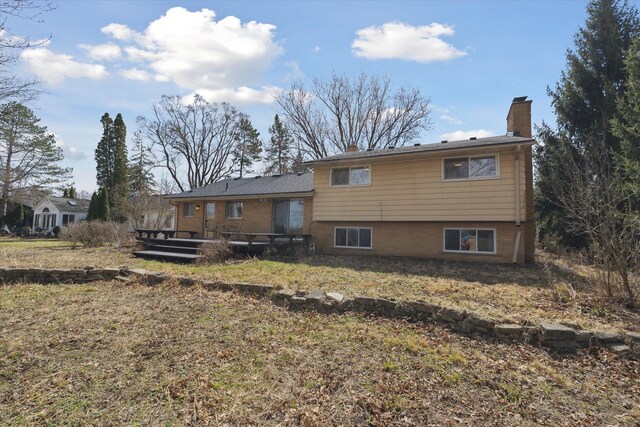 711 Sylvanwood Dr, Troy, MI 48085 - back of property with a wooden deck and a chimney