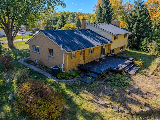 711 Sylvanwood Dr, Troy, MI 48085 - back of house with brick siding, a chimney, central AC unit, and a wooden deck