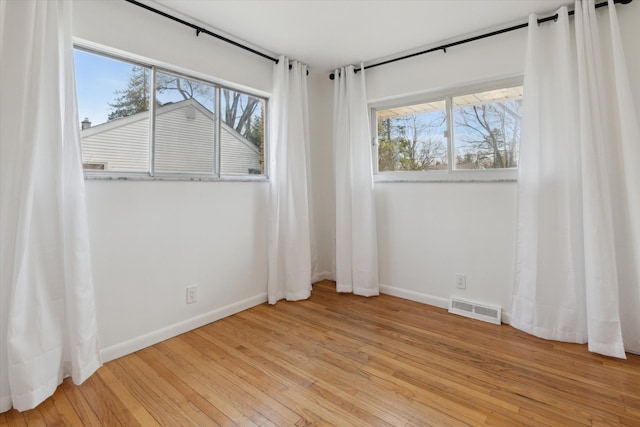 711 Sylvanwood Dr, Troy, MI 48085 - unfurnished room with a healthy amount of sunlight, baseboards, light wood finished floors, and visible vents