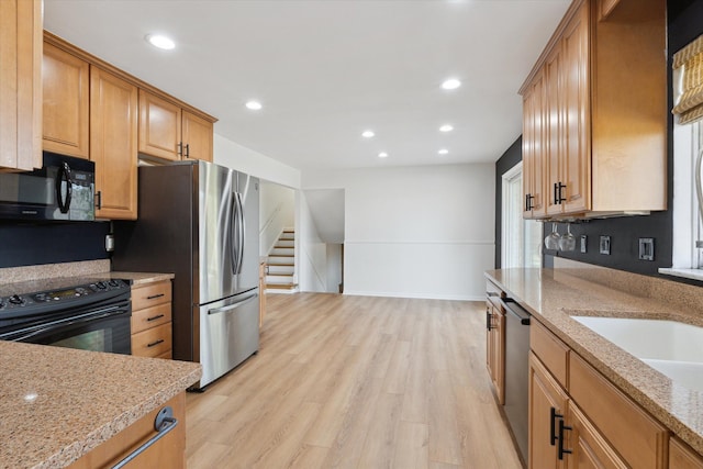 711 Sylvanwood Dr, Troy, MI 48085 - kitchen featuring recessed lighting, light stone counters, black appliances, and light wood-type flooring