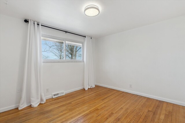 711 Sylvanwood Dr, Troy, MI 48085 - unfurnished room with baseboards, visible vents, and light wood-style floors