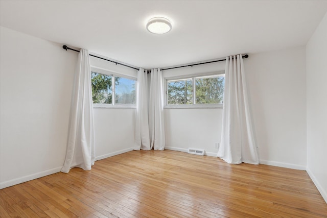 711 Sylvanwood Dr, Troy, MI 48085 - unfurnished room featuring baseboards, light wood-style flooring, and visible vents