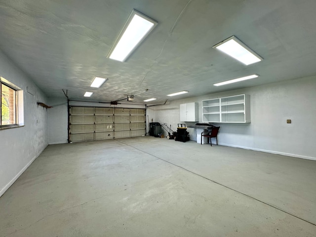 711 Sylvanwood Dr, Troy, MI 48085 - garage featuring baseboards and a garage door opener