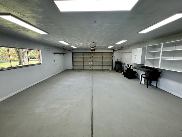 711 Sylvanwood Dr, Troy, MI 48085 - garage featuring baseboards and a garage door opener