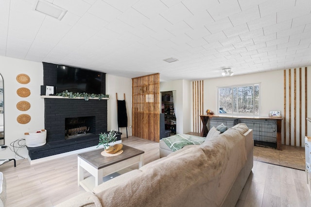 8119 N Dort Hwy, Mount Morris, MI 48458 - living area featuring light wood-type flooring and a fireplace